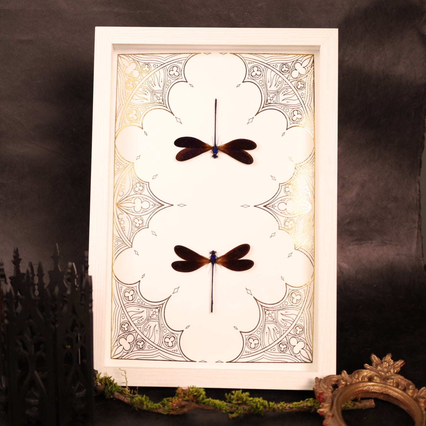 Dragonflies on a gold background in a frame with a Gothic design