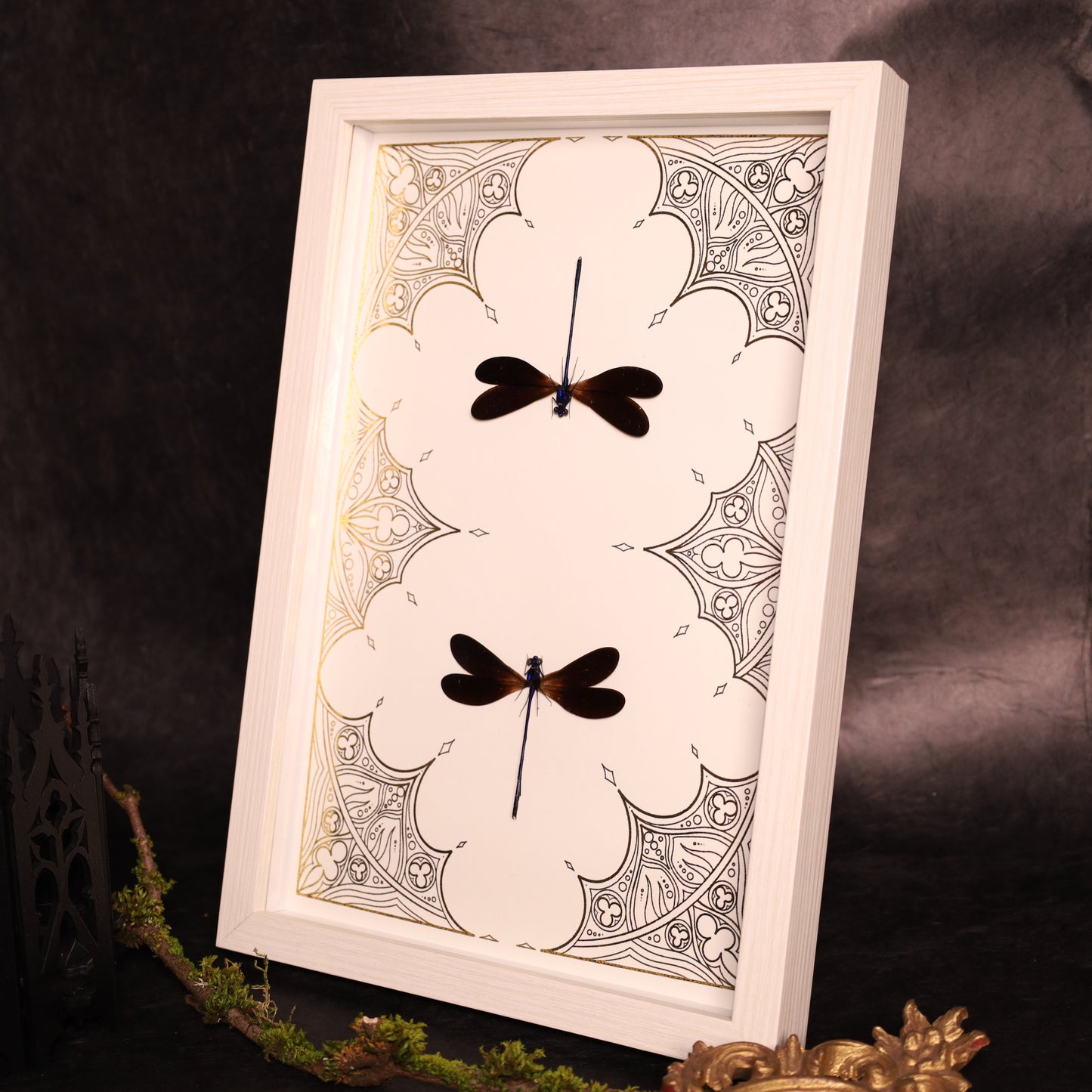 Dragonflies on a gold background in a frame with a Gothic design