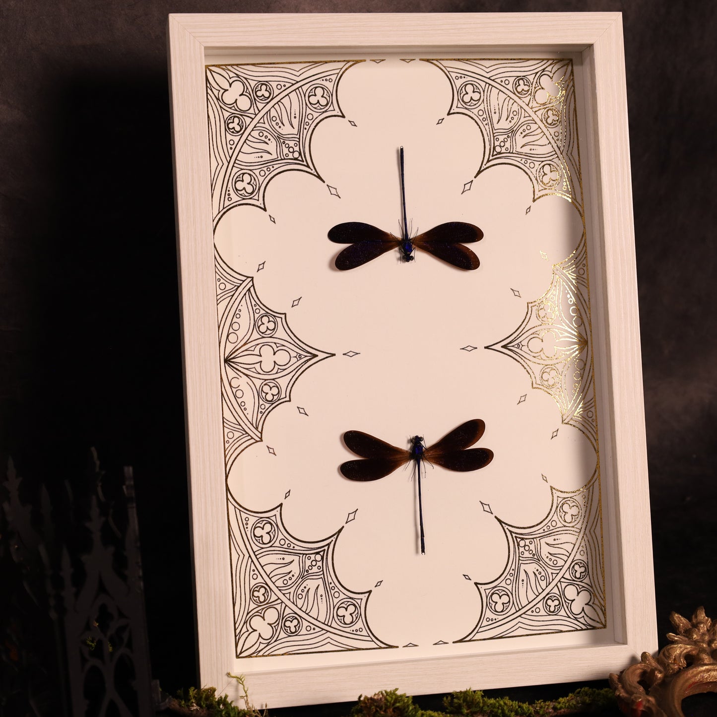 Dragonflies on a gold background in a frame with a Gothic design